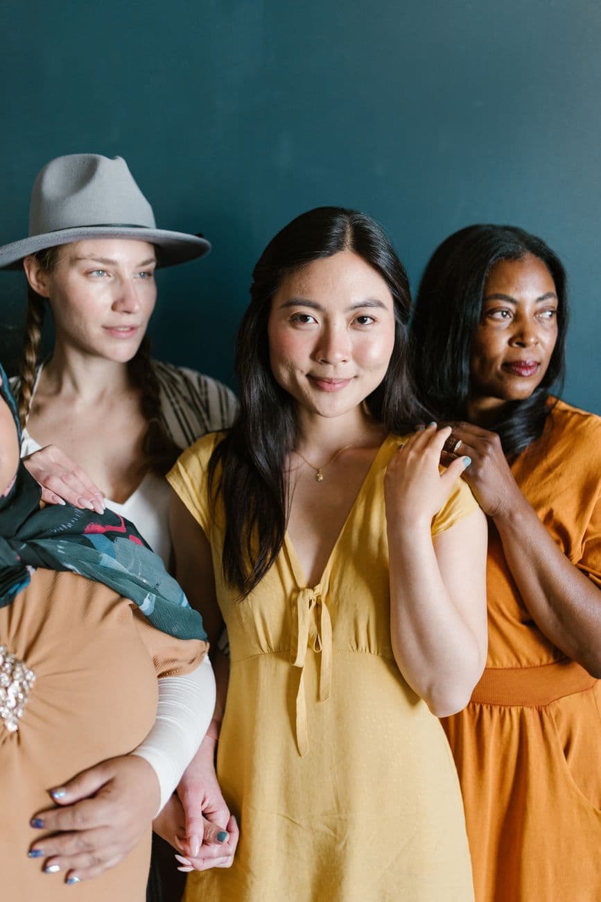 A group of women of different races and backgrounds standing together, the community of the Mental Wealth Collective