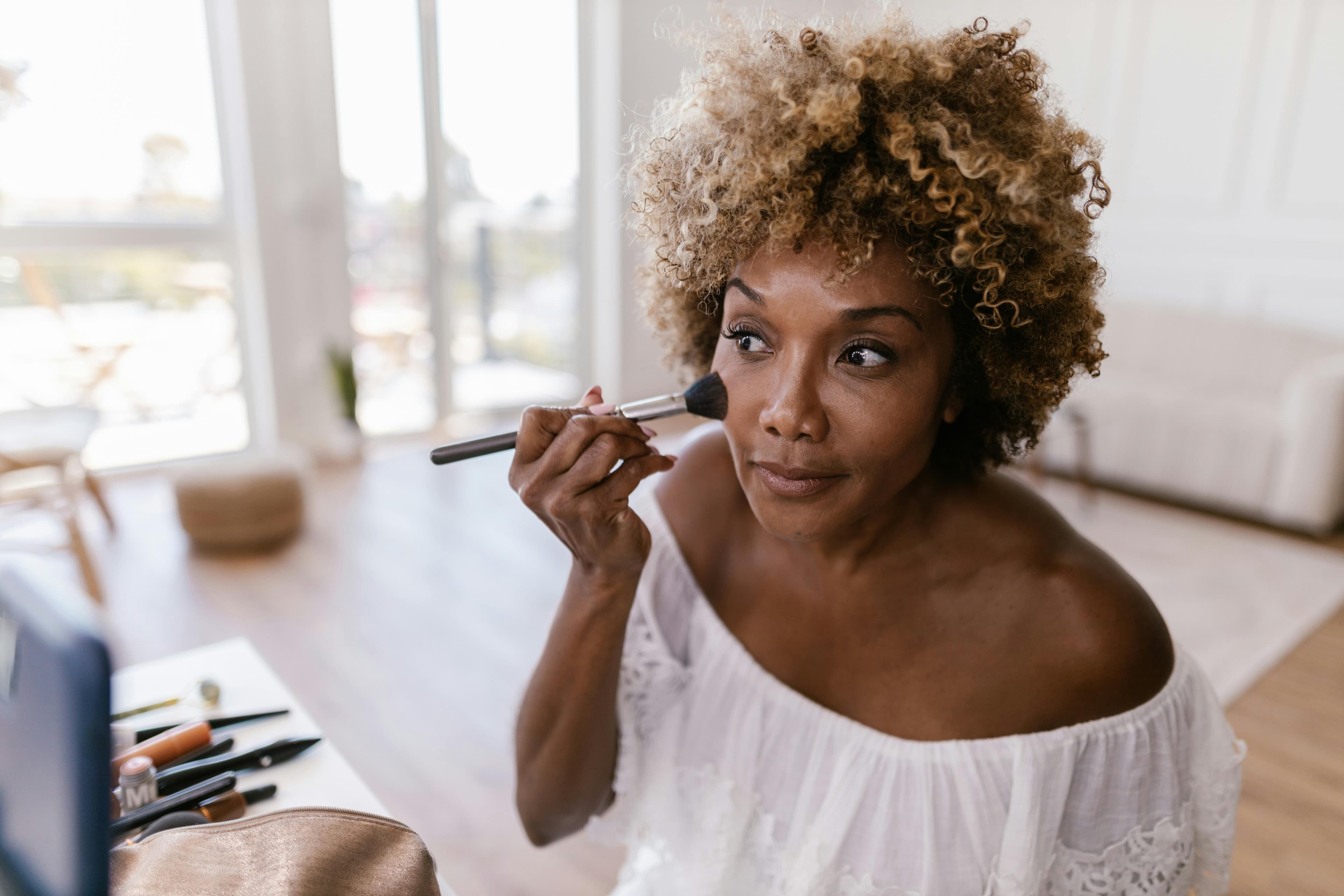 Woman applying makeup — a quiet moment of self-care
